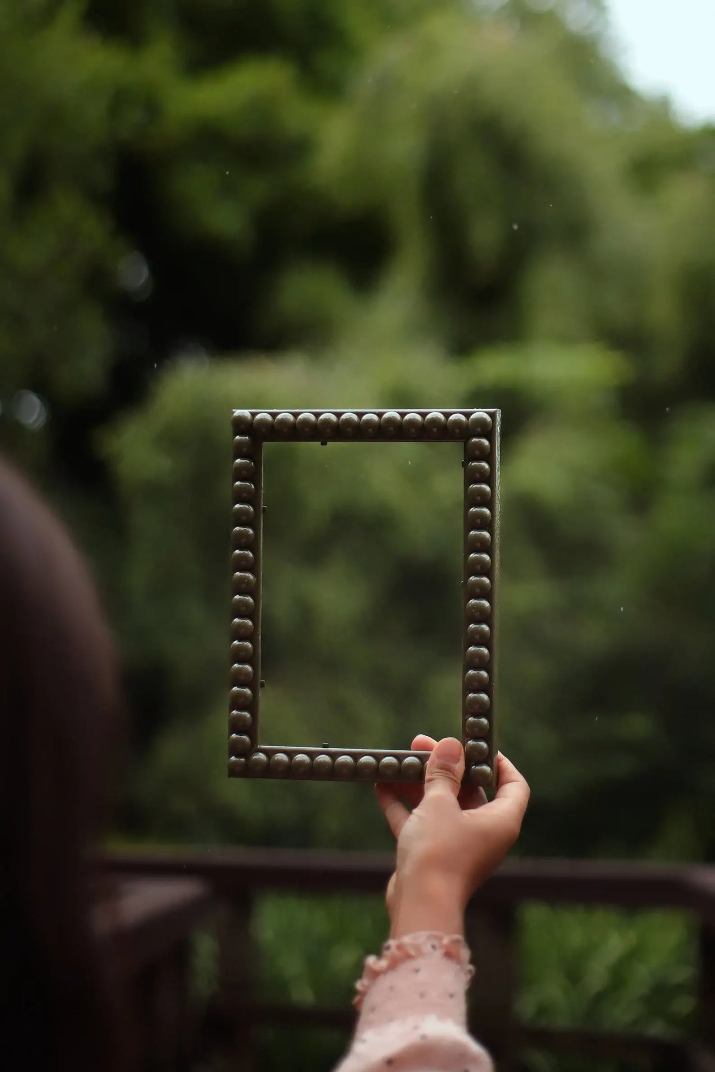 Hand holding Olive Green Bobbin Frame